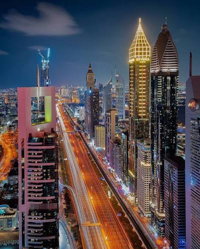 A boulevard running into the skyline at night