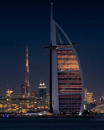 The sail-shaped hotel at night, Bur Dubai behind it