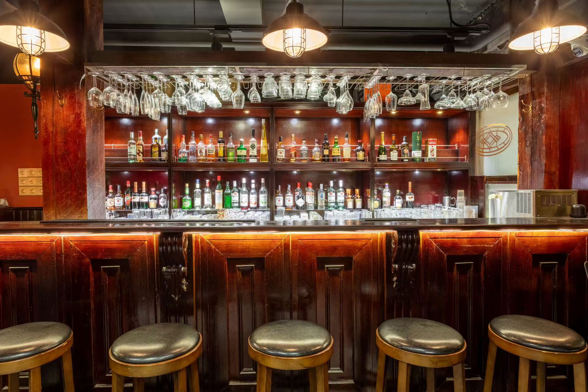 Ground floor bar, wooden counter, bottle display and stools