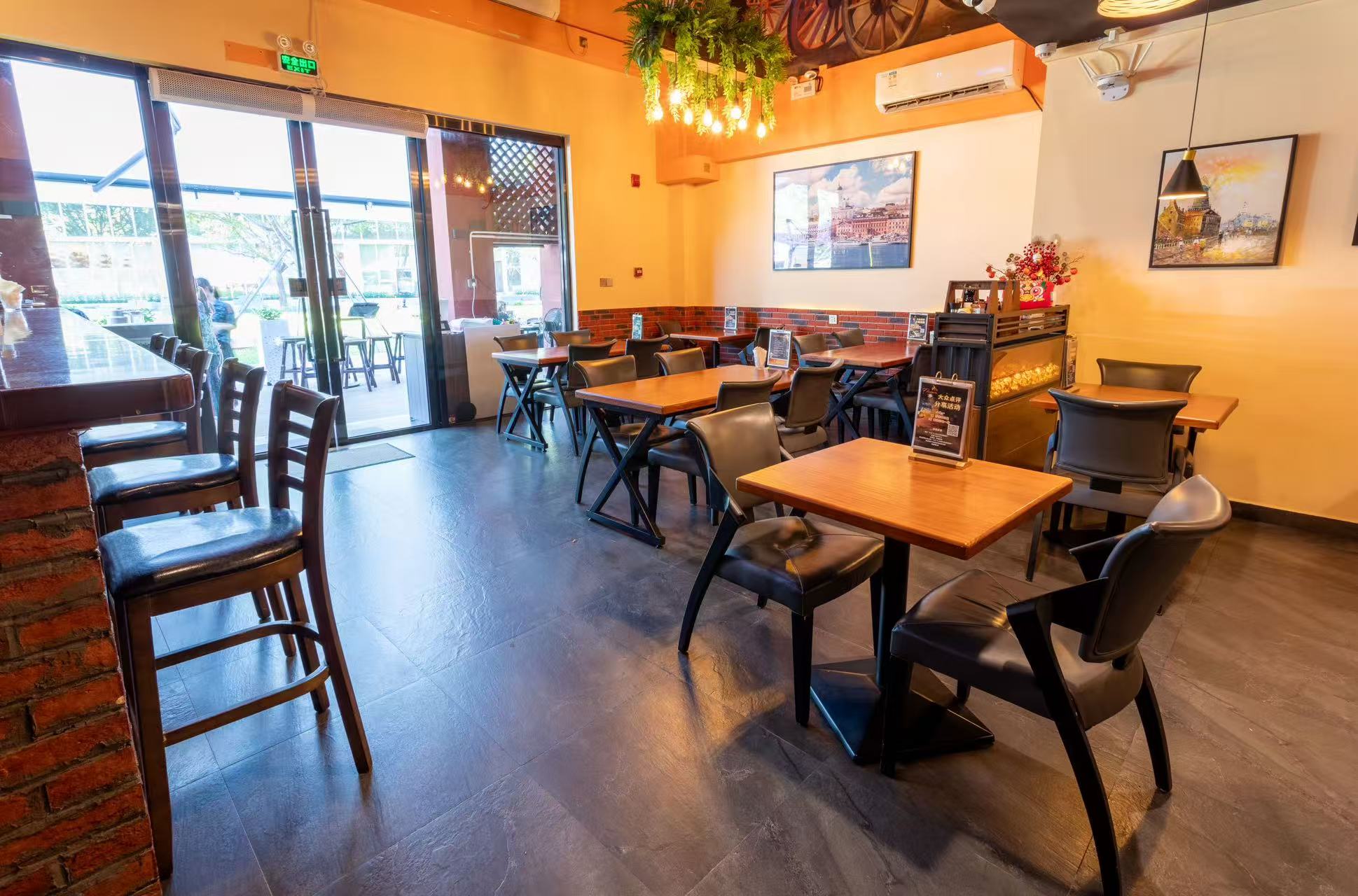 Dining room with wooden tables, brick wall and fireplace