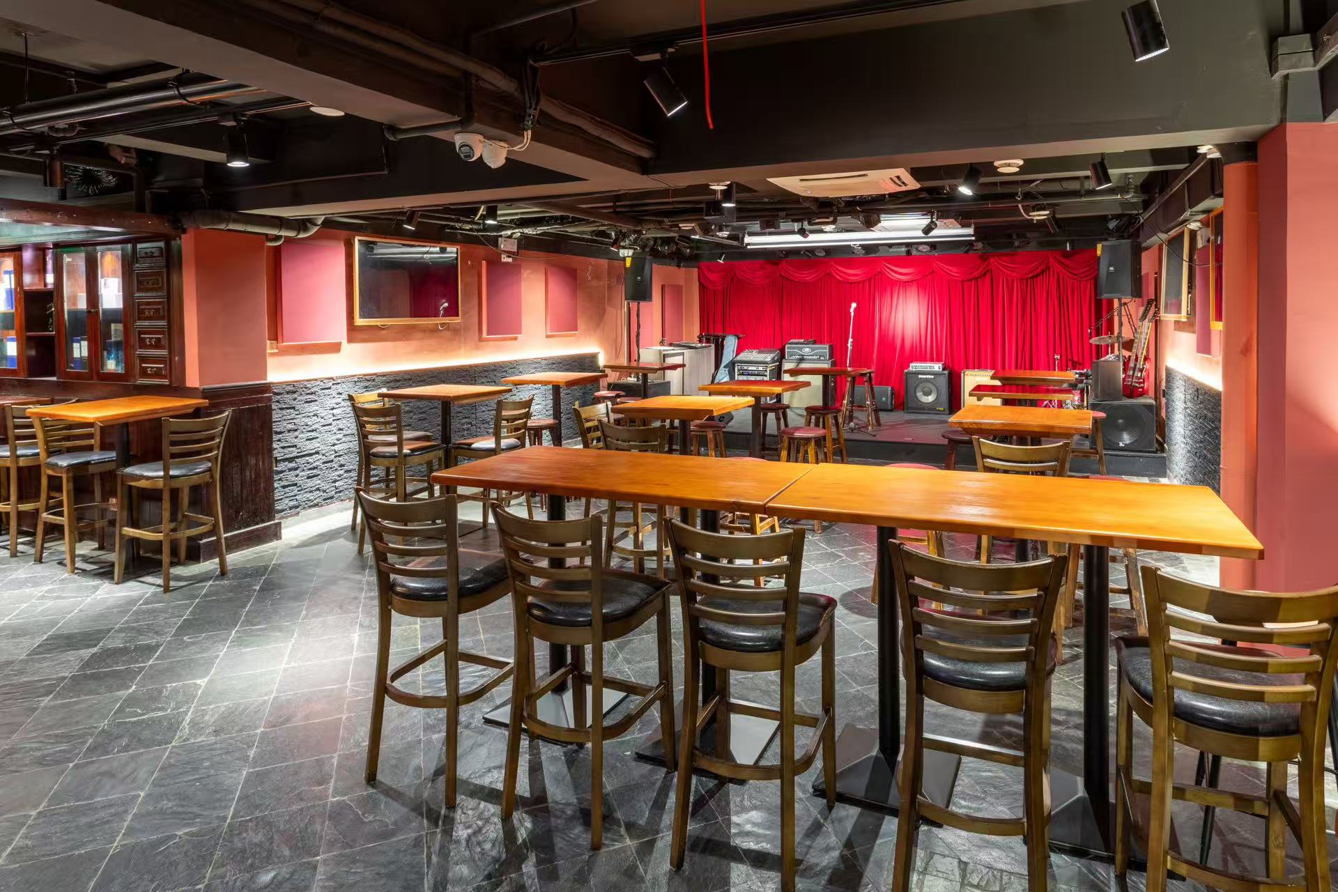 Second floor room set up with high tables facing the stage